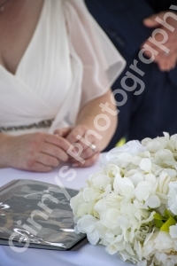 Close up shot of the wedding flowers and signing the register