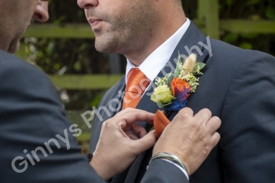 button hole being placed onto the best man at a wedding